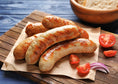 Load image into Gallery viewer, grilled bratwurst grass-fed and finished meat. regeneratively raised. Bratwurst sausages on parchment paper atop a wooden board
