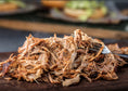 Load image into Gallery viewer, Northstar Bison fully cooked shredded chicken made from corn and soy free chicken resting on a cutting board, tender and juicy

